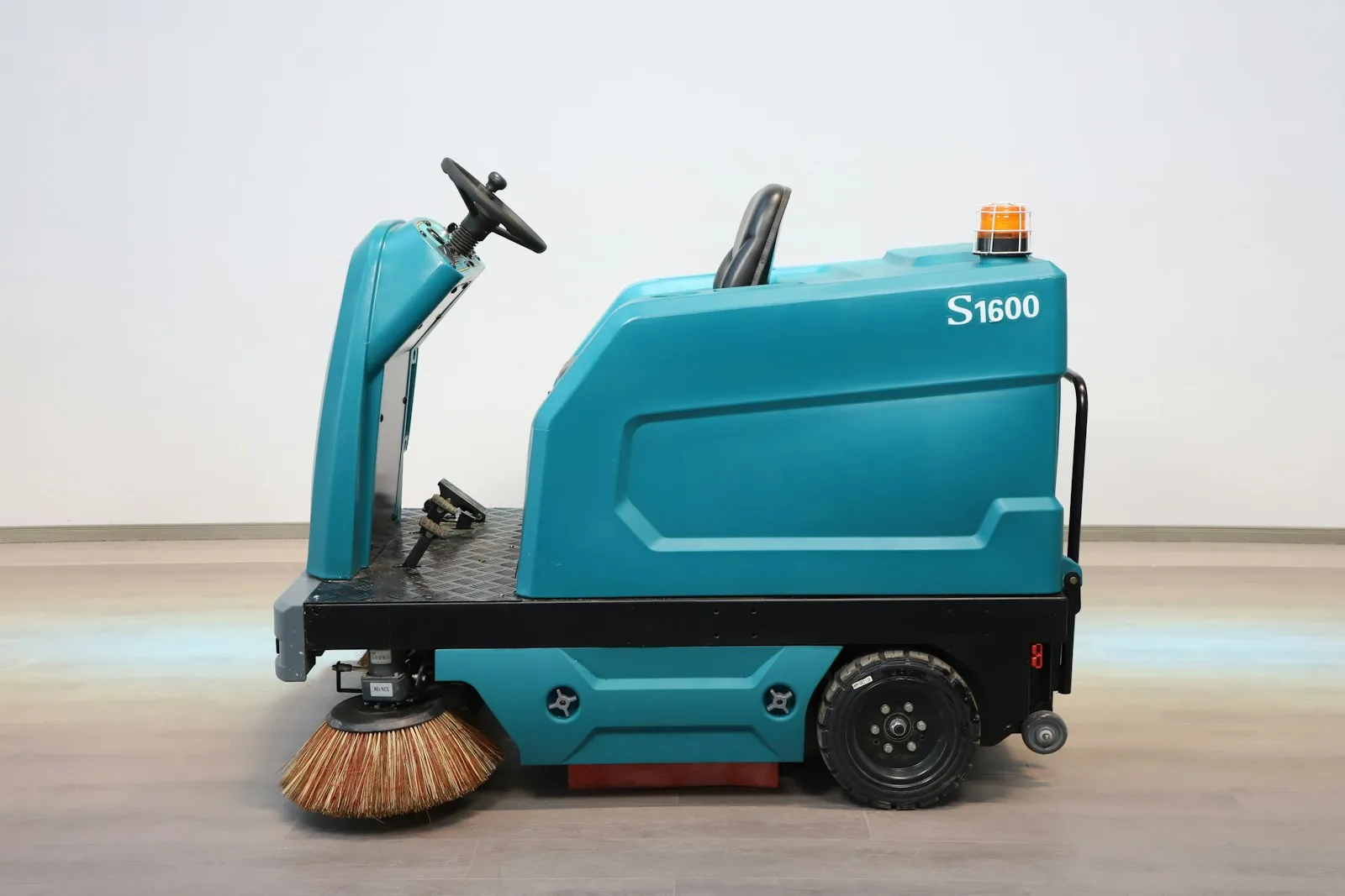 A ride-on commercial floor scrubbing machine