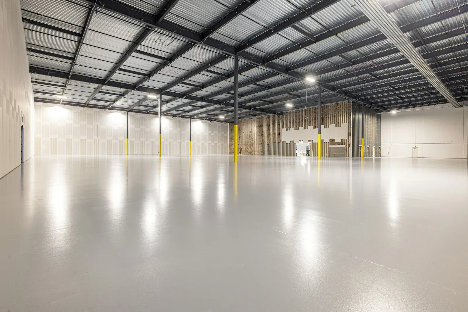 A warehouse interior with a large sealed concrete floor