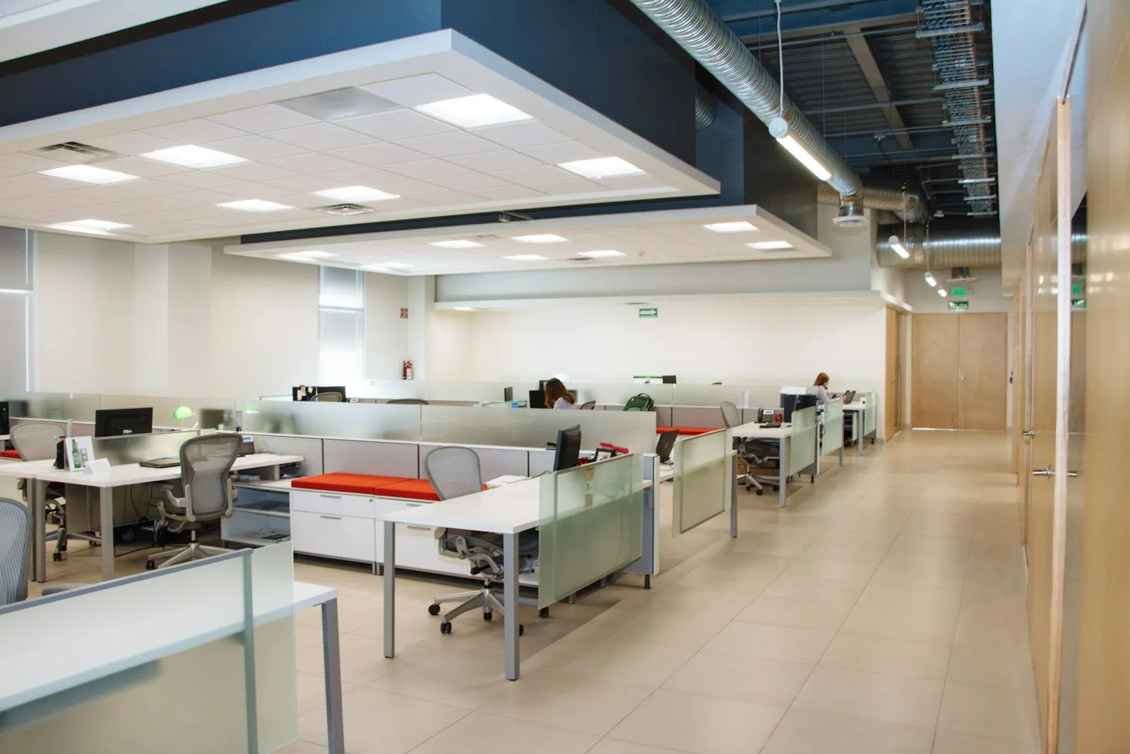 An open-plan office floor with desks and partitions